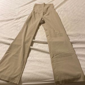 Women’s maternity tan dress pants with high belly band.